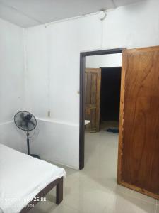 a room with a door leading to a room with a doorway at Reefside Retreat by B'lu Bamboo in Moalboal