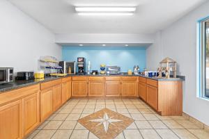 a large kitchen with wooden cabinets and a star on the floor at Days Inn by Wyndham Cleveland TN in Cleveland
