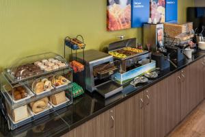 a buffet line with various types of donuts and pastries at Comfort Inn in Yarmouth