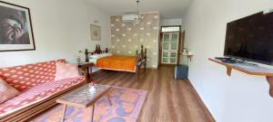 a living room with a couch and a tv at Morjim Plaza in Morjim