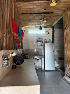 a kitchen with a white refrigerator and a table at Joey's Homestay in Rishīkesh +46 photos