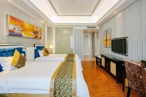 Giường trong phòng chung tại Kai Dun Hotel +264 ảnh