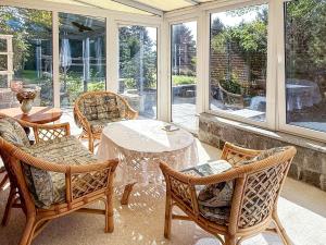 a screened in porch with a table and chairs at Ferienhaus Wilmshagen in Südhof