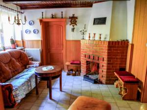 a living room with a couch and a fireplace at Ferienhaus Wilmshagen in Südhof +7 photos