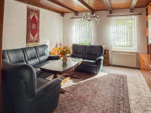 a living room with two couches and a coffee table at Ferienhaus Wilmshagen in Südhof
