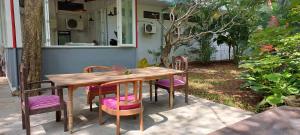 a wooden table and chairs outside of a house at Morjim Plaza in Morjim