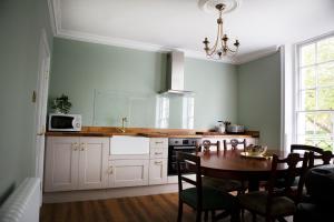 a kitchen with a table and a dining room at Grade II listed 3 bed townhouse in Exeter, Devon in Exeter