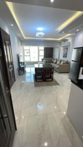 a living room with a couch and a table at Doki sky suite in Cairo