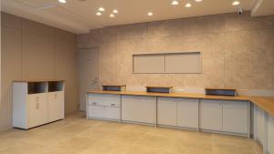 a room with a counter and a projection screen on the wall at Toyoko Inn Tokyo Minowa-eki in Tokyo +39 photos