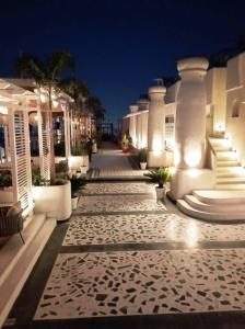 a walkway in front of a building at night at A N Studio Room, The Grand Anukampa in Jaipur