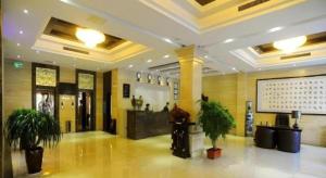 a lobby with potted plants in a building at GreenTree Eastern Yantai Development Zone Zhujiang Road Hotel in Yantai