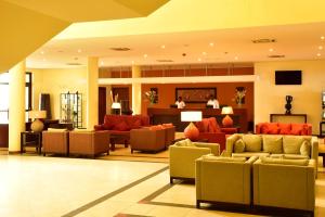 a lobby with couches and chairs in a hotel at Pestana Sao Tome in São Tomé