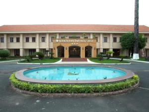 a building with a large pool in front of it at Tan Son Nhat Hotel in Ho Chi Minh City