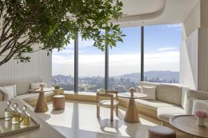 a living room with a view of a city at Park Hyatt Kuala Lumpur in Kuala Lumpur