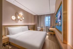 Postel nebo postele na pokoji v ubytování Orange Hotel Chengdu Shuangliu International Airport