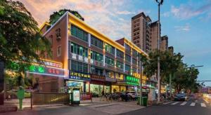 a building on the side of a city street at GreenTree Inn Hainan Haikou Jinniu Road Business Hotel in Haikou
