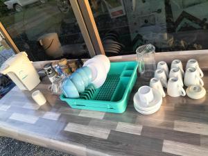 a table with a tray of cups and dishes at Shah Hill Hut in Phra Ae beach +85 photos