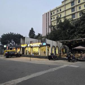 a store with motorcycles parked in front of a building at Luxury Studio Apartment in Bareilly in Bareilly