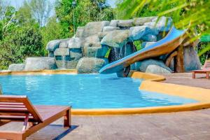 a water slide in a pool with a waterfall at Water Jade Natural Resort in Ban Bo Dan