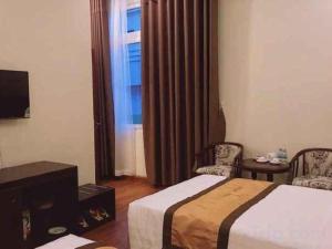 a hotel room with a bed and a window at LUCKY STAR HOTEL in Buon Ma Thuot +36 photos