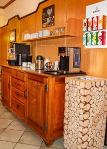 a kitchen with wooden cabinets and a counter top at Hotel-Restaurant Gasthaus Bonimeier in Niedergottsau +42 photos