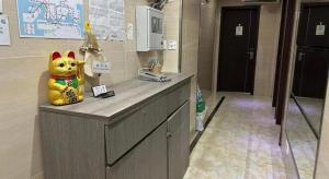 a kitchen counter with a stuffed animal on top of it at New Star Guest House in Hong Kong