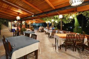 a restaurant with tables and chairs and people sitting at St. Nicholas Pension in Patara