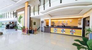 a lobby of a hospital with a counter in the middle at The Ritz Hotel at Garden Oases in Cabaguio +200 photos