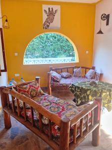 Postel nebo postele na pokoji v ubytování SIMBA House