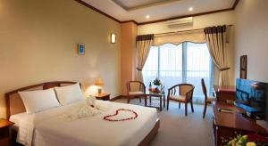 a hotel room with a bed and a television at CWD Hotel in Hanoi +107 photos