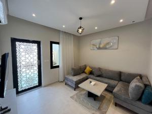 una sala de estar con un sofá y una mesa en شقق الضيافة الخاصه, en Yeda