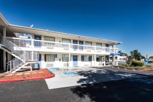 an apartment building with a staircase in a parking lot at Motel 6-Sparks, NV - Airport - Sparks in Reno