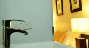 a bathroom with a sink and a faucet in a room at 26 Loversleap Cottage in Nuwara Eliya