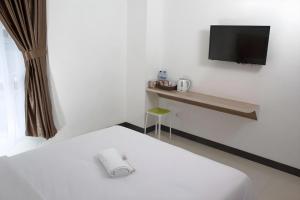 Postel nebo postele na pokoji v ubytování Sakura Manado + 91 fotografií