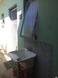a bathroom with a white sink and a window at Hostel São Francisco 3 in Votorantim