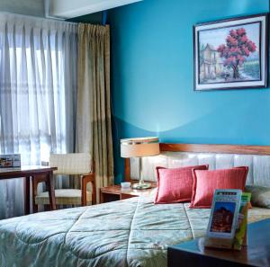 Voodi või voodid majutusasutuse Cesar's Plaza Hotel toas