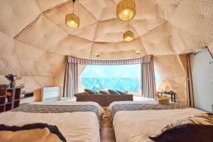 Postel nebo postele na pokoji v ubytování リバーサイドグランピングNuts