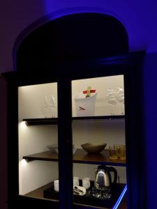 um armário cheio de pratos e um bule de chá em Maga Mirì Relais Suite em Spinazzola
