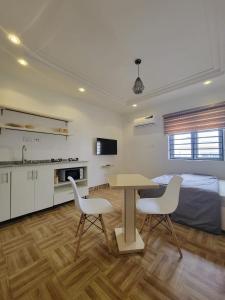 a room with a table and two chairs and a bed at Lovely self contained unit in a secure estate in Abuja