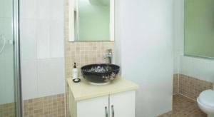 a bathroom with a black sink and a shower at Super 8 Hotel Chengde Imperial Summer Resort in Chengde