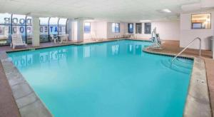 a large pool with blue water in a hotel room at Super 8 By Wyndham Garland North Dallas Area in White Rock