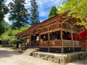 a small wooden building with steps in front of it at Miyajima Morinoyado in Miyajima