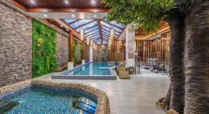 a swimming pool in the middle of a building at GreenTree Inn Kunming Baiyun Road Tongde Plaza Branch in Kunming