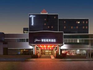 a building with a sign on the front of it at Zmax Hotel·Yantai Shimao Binhai Plaza in Yantai