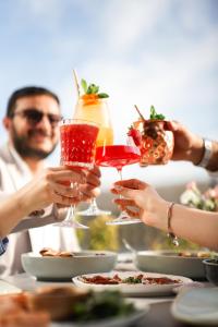 a group of people holding up wine glasses at a table at Holiday Inn Yerevan - Republic Square by IHG in Yerevan