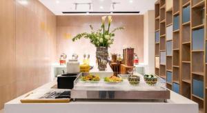 a kitchen with bowls of food on a counter at Echarm Hotel Xiamen Airport Huojuyuan Metro Station in Xiamen