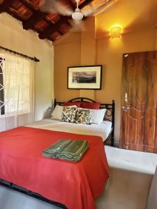 a bedroom with a large bed with a red blanket at Solaya Living - Boutique Holiday Home - 1 min to the beach in Magdāl
