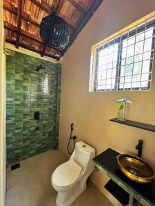 a bathroom with a toilet and a sink and a shower at Solaya Living - Boutique Holiday Home - 1 min to the beach in Magdāl