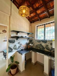a kitchen with a large counter with a potted plant at Solaya Living - Boutique Holiday Home - 1 min to the beach in Magdāl