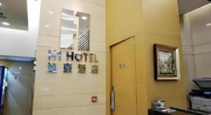 una habitación con un cartel de hotel en una pared en H1 Hotel, en Hong Kong